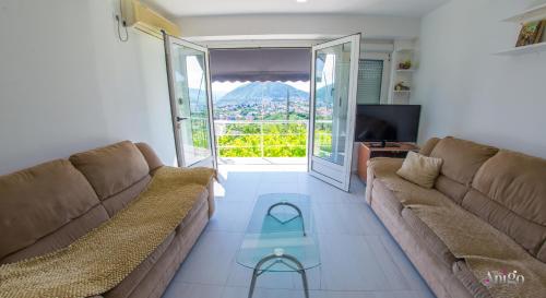 a living room with a couch and a glass table at Perfect view of Mostar - with swimming pool in Mostar