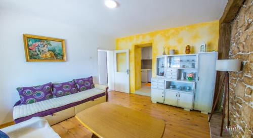 a living room with a couch and a table at Perfect view of Mostar - with swimming pool in Mostar