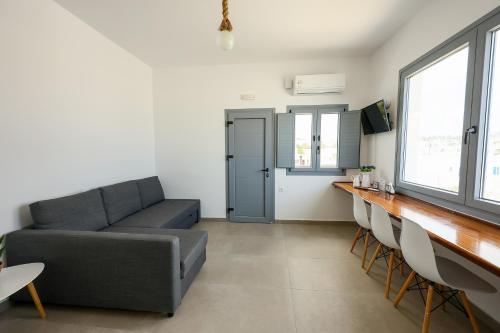a living room with a couch and a table and chairs at Aerial Apartment in Karterados