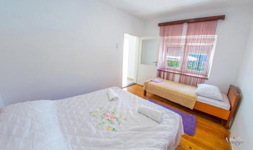 a bedroom with a bed and a window at Perfect view of Mostar - with swimming pool in Mostar