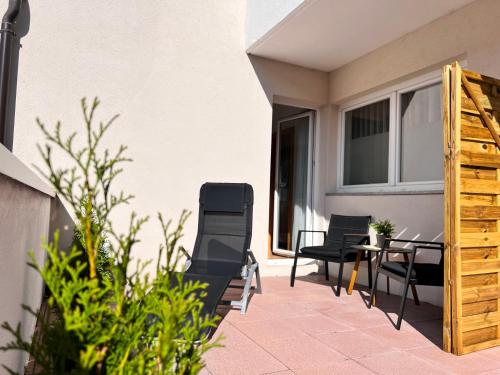 a patio with chairs and a table on a patio at Appart Kofler in Gerlos