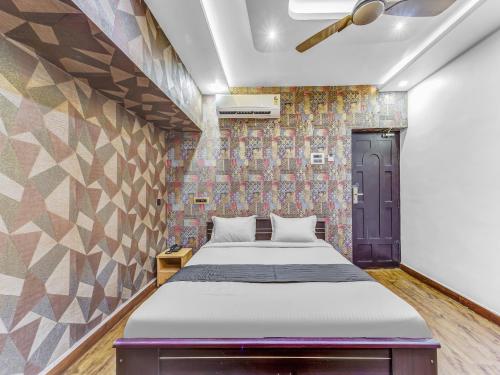a bedroom with a bed and a wall with tiles at Bella Vagues Beach Resort in Chennai