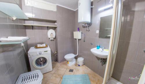 a bathroom with a washing machine and a sink at Perfect view of Mostar - with swimming pool in Mostar