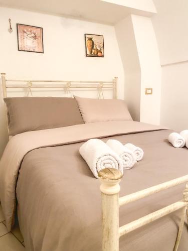 a bedroom with a bed with towels on it at Nonno Pasquale house in Locorotondo