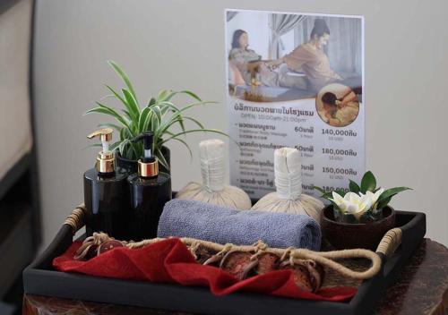a tray with bottles and plants on a table at Le Thatluang D'oR Boutique Hotel in Vientiane