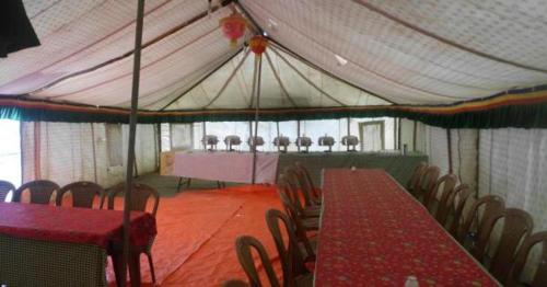 a tent with tables and chairs in a room at Golden Mark Cottage Tsomoriri Lake in Leh