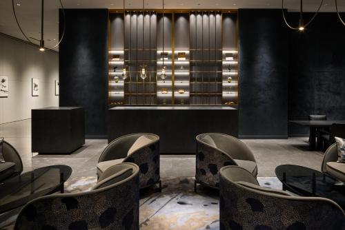 a waiting room with chairs and tables and lights at BELLUSTAR TOKYO, A Pan Pacific Hotel in Tokyo