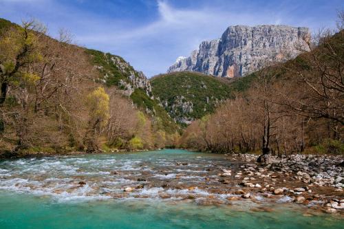 a river with a mountain in the background at Konitsa Mountain Hotel in Konitsa