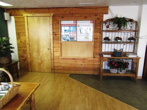 a room with a door and a shelf with plants at Yellowstone Country Inn in West Yellowstone