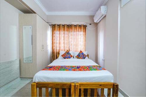 a bedroom with a large bed in a room at FabHotel Lepsi Inn in Bangalore