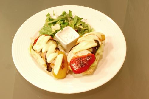 a plate of food with a sandwich and a salad at Holiday Inn Łódź by IHG in Łódź