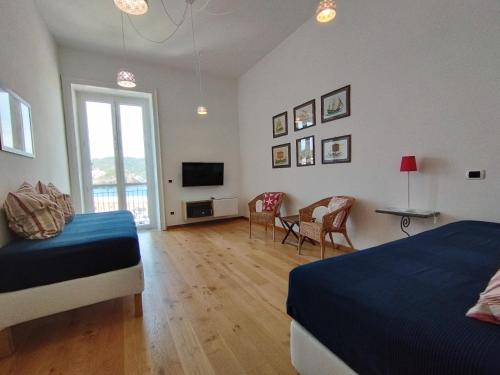 a bedroom with two beds and a television in it at Locanda Mari in Ponza