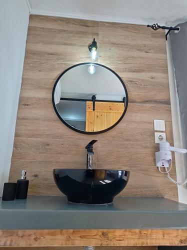 a bathroom with a black sink and a mirror at Maistrali in Provatas