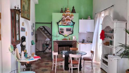 a kitchen with a table and chairs in a room at Il Camaleonte in Bracciano