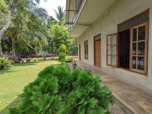 an outside view of a house with a yard at Afenta Motel- Mihintale in Mihintale
