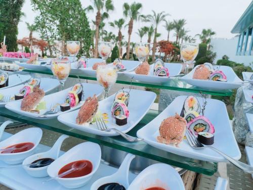 a row of plates of food on a table at Happy Life Village Dahab in Dahab