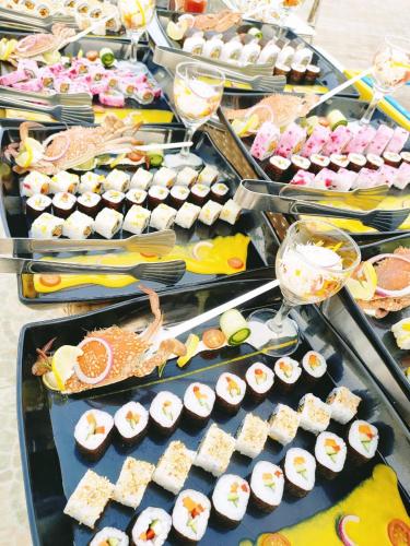 a buffet line with sushi and other food items at Happy Life Village Dahab in Dahab