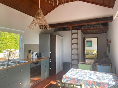 a kitchen with a sink and a kitchen with a table at A House in The Woods in Sintra