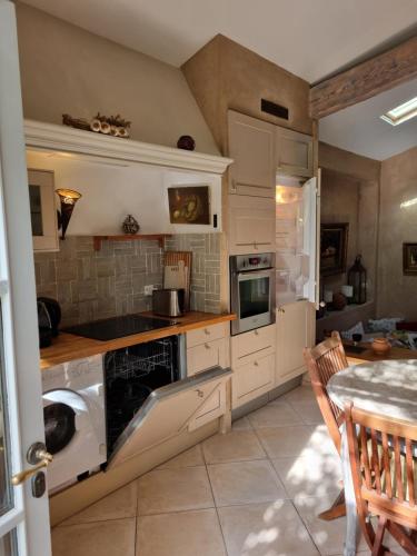 a kitchen with a washer and dryer in it at Mas de la Petite Jeanne in Grimaud