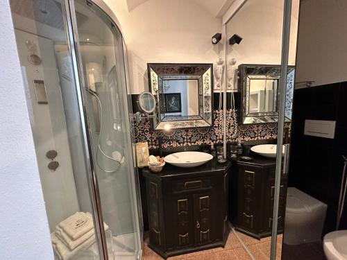 a bathroom with two sinks and a shower at Domus Socolatae Residenza d'Epoca Charming B&B - Adults Only in Follonica