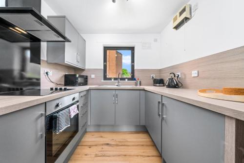 a kitchen with stainless steel appliances and a counter top at Flat in Glasgow City in Glasgow