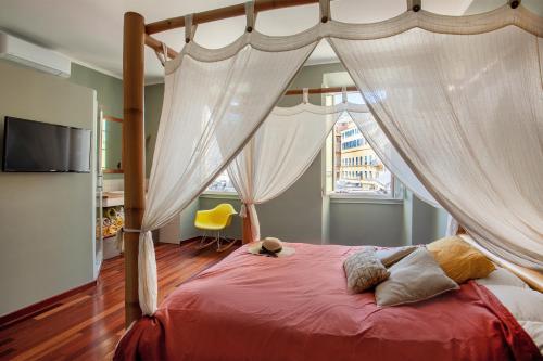 a bedroom with a canopy bed with curtains at Casa Marina in Bastia