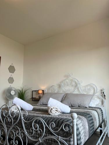 a white bedroom with a metal bed with white walls at Panorama in Someraro