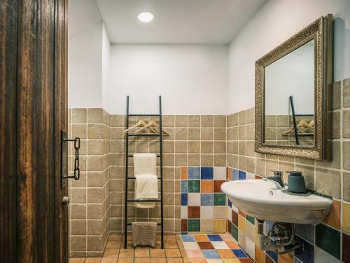 a bathroom with a sink and a mirror at Deep Breath B&B in Fengshan