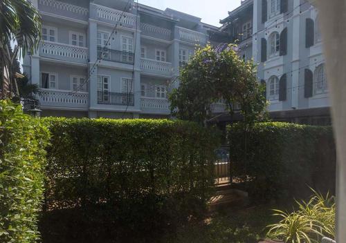 a building with a hedge in front of a building at Le Thatluang D'oR Boutique Hotel in Vientiane