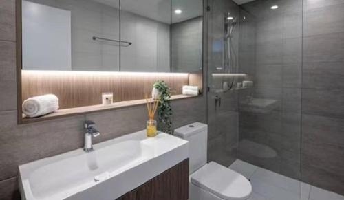 a bathroom with a sink and a toilet and a shower at Luxury Casino Apartment in Broadbeach Island in Gold Coast