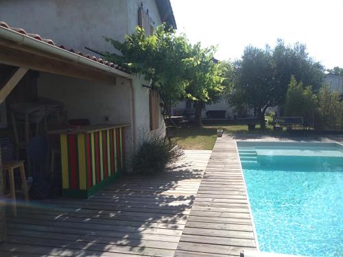 a house with a swimming pool next to a building at La Maison du Béchon in Blanquefort