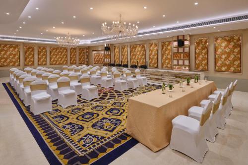 a banquet hall with tables and chairs and chandeliers at Zone by The Park, Jammu in Jammu