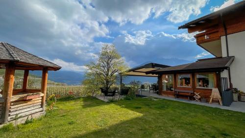 a house with a yard with a view at Tirolerhof Pension in Naz-Sciaves