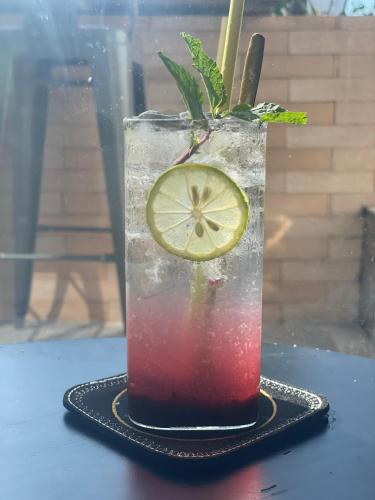 a drink in a glass with a slice of lime at Dreamers Farm in Vinh Thanh