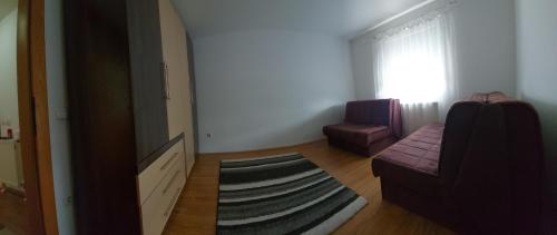 a living room with a couch and a chair at Boulevard Mitrovica in Mitrovicë