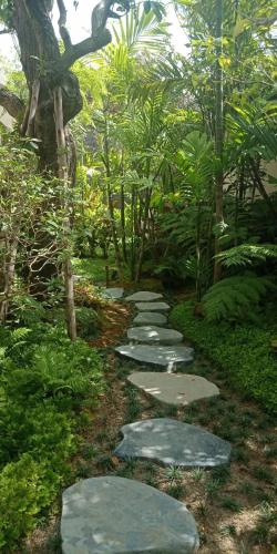 a path in a garden with stepping stones at Rarin Villas in Chiang Mai