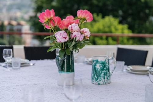 a vase of pink flowers sitting on a table at Villa Aurora in Vico Equense