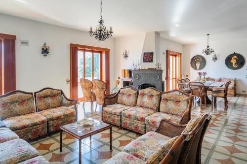 a living room with couches and a table at Villa Aurora in Vico Equense
