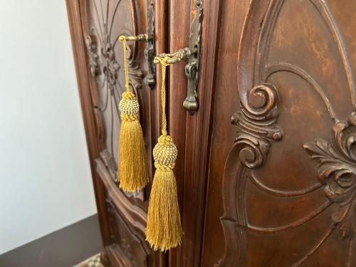 a wooden door with t earrings on it at Domus Socolatae Residenza d'Epoca Charming B&B - Adults Only in Follonica