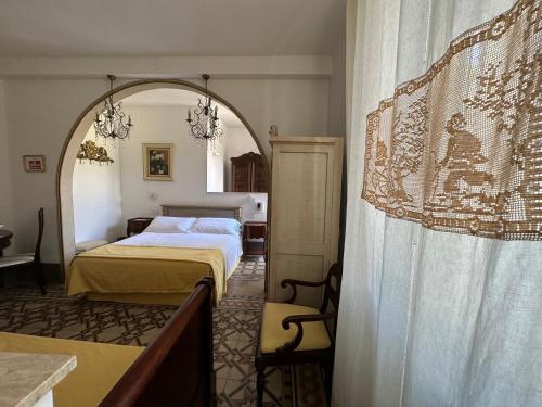 a bedroom with a bed and an arched window at Domus Socolatae Residenza d'Epoca Charming B&B - Adults Only in Follonica