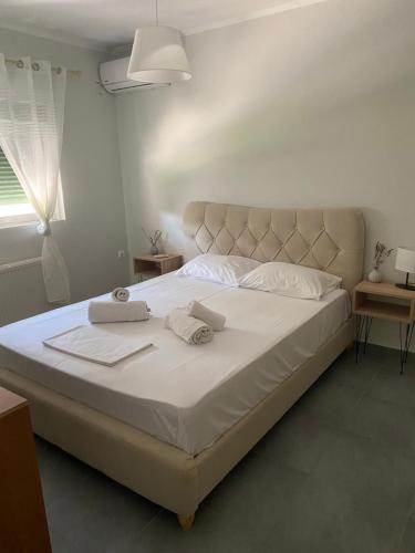a bedroom with a large bed with two towels on it at Lefkada Town Apartment in Lefkada Town