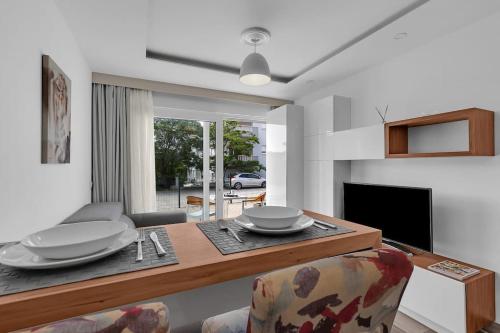a living room with a dining room table with plates on it at Brotis - StudioApartment in Promajna