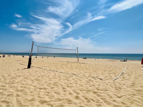 a volley ball net on a sandy beach at The Oasis - Stylish one bedroom apartment - Mudeford in Burton