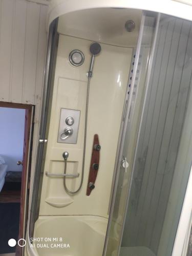 a shower in a room with a gun on the wall at Apartment in Kaunas center in Kaunas