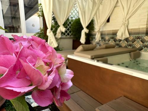 a purple flower in a vase in a room at Domus Socolatae Residenza d'Epoca Charming B&B - Adults Only in Follonica