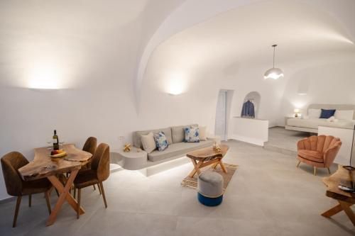 a living room with a couch and a table at Sun Angelos Oia - Luxury Cave Suites in Oia