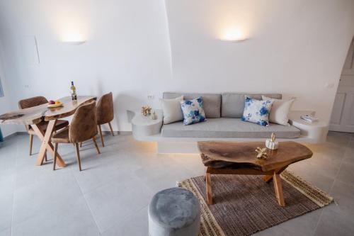 a living room with a couch and a table at Sun Angelos Oia - Luxury Cave Suites in Oia
