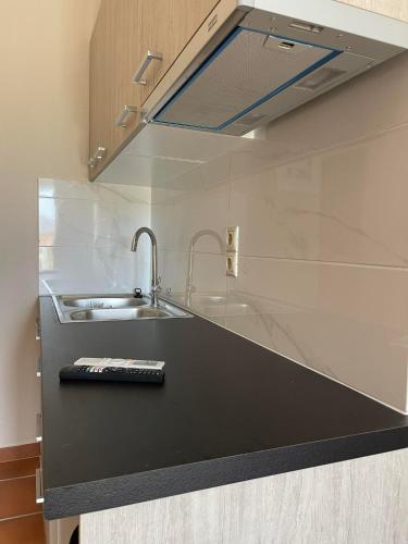 a kitchen with a sink and a counter top at ALLAGIANNIS GROUP APARTMENTS in Markopoulo
