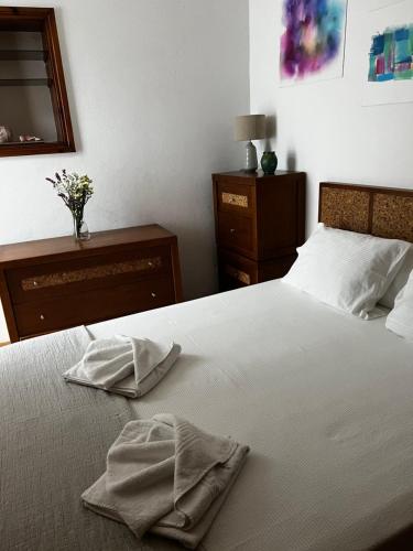 a bedroom with a bed with two towels on it at CELLARS CENTER HOUSE in Vila Nova de Gaia