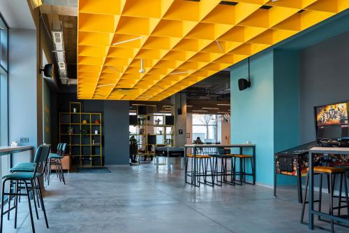 una stanza con sedie e tavoli e un soffitto giallo di Hotel Campus 90 - Free Parking a Varna